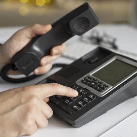 close-up-businessman-dialling-phone-number