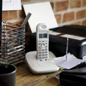 Closeup of landline phone on wooden table